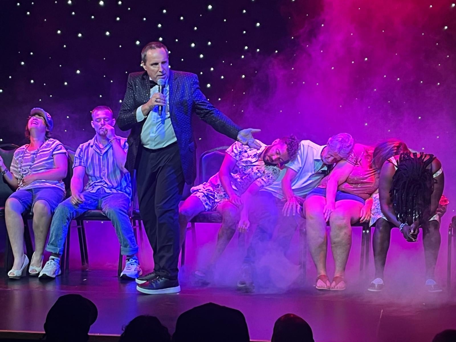 Richard Barker on stage with hypnotized volunteers at the Wonders Theatre in Myrtle Beach